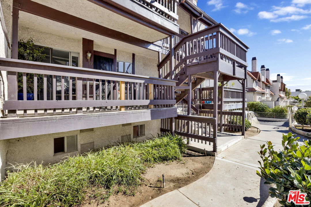 12330 Osborne Street, Unit 77 Pacoima, CA 91331 - Photo 27 of 32 a view of a house with a small yard