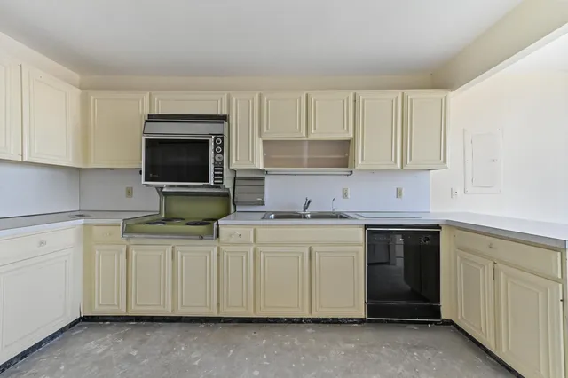 an empty room with large windows and painted walls