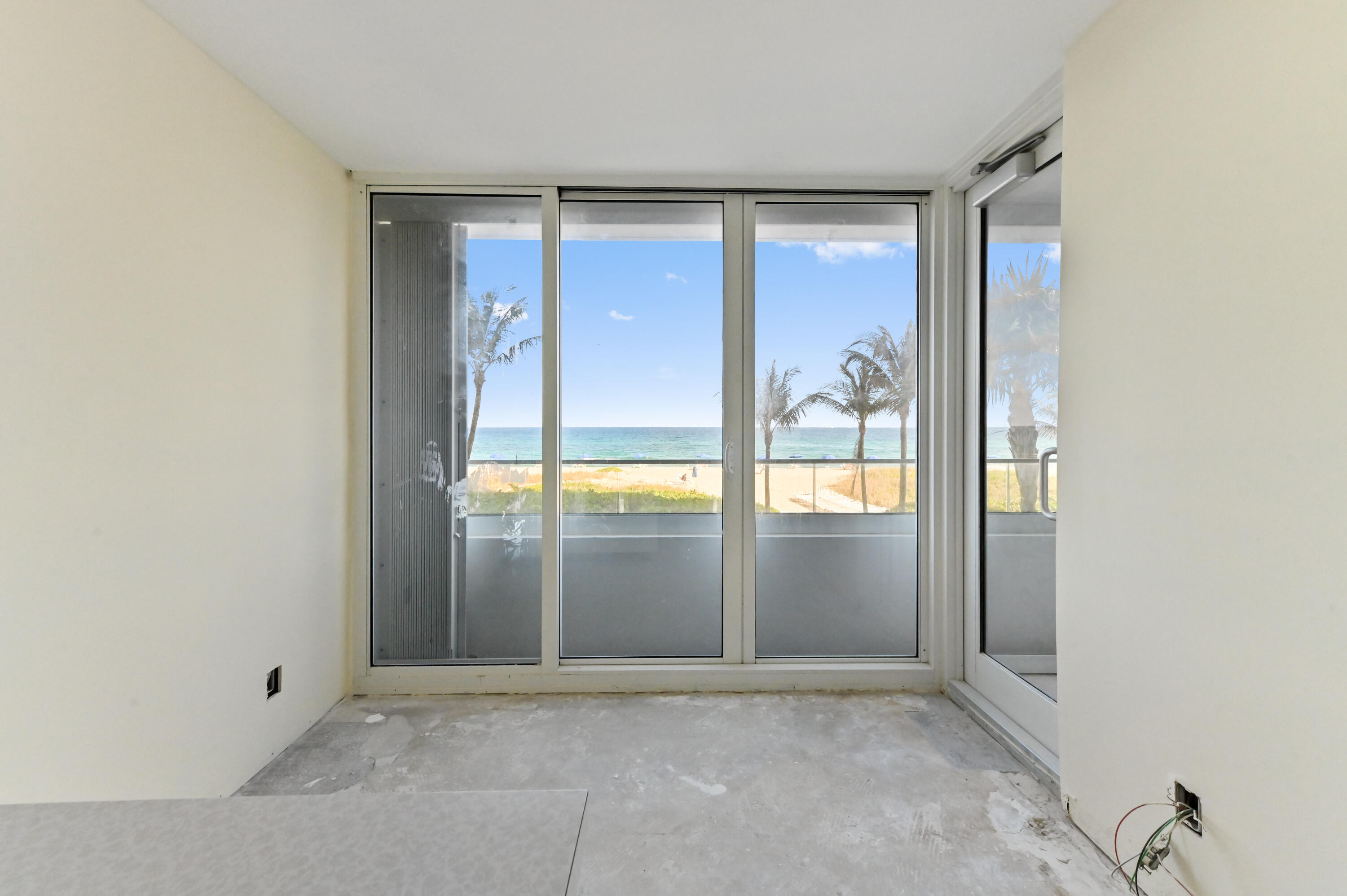 2800 South Ocean Boulevard, Unit 2K Boca Raton, FL 33432 - Photo 12 of 59 an empty room with large windows and painted walls
