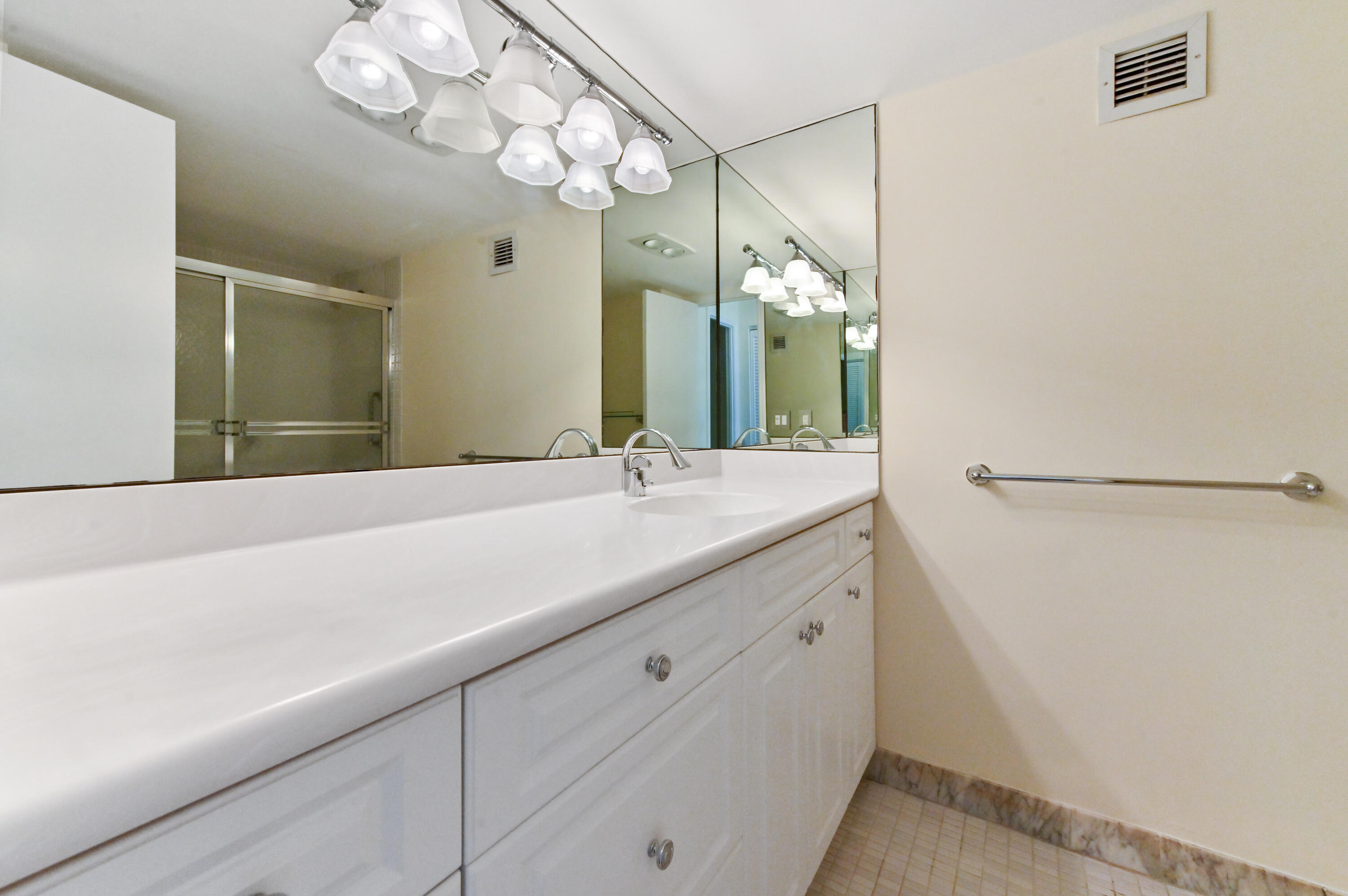 2800 South Ocean Boulevard, Unit 2K Boca Raton, FL 33432 - Photo 20 of 59 a bathroom with a sink a large mirror and a shower