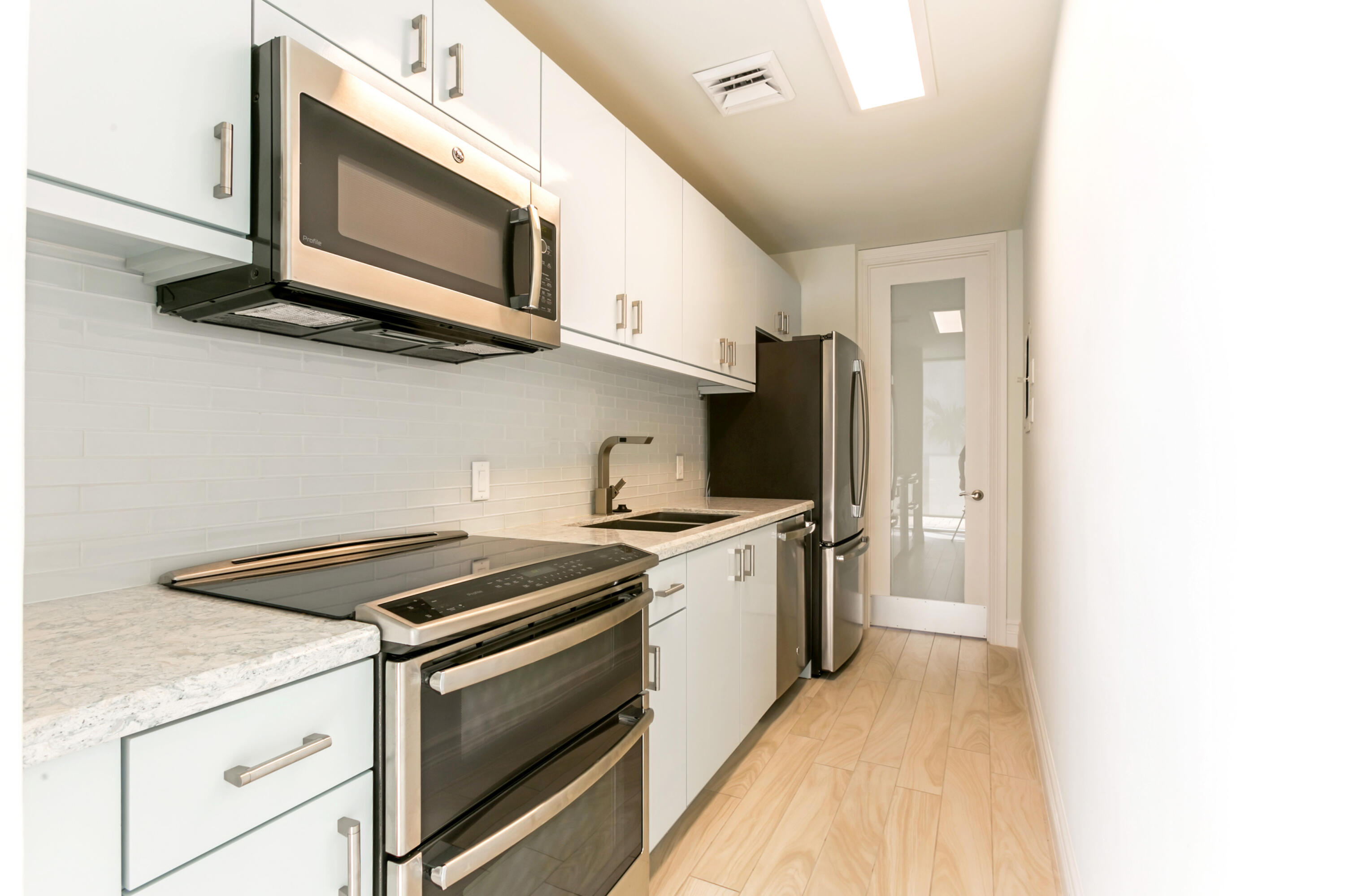2800 South Ocean Boulevard, Unit 2K Boca Raton, FL 33432 - Photo 37 of 59 a kitchen with stainless steel appliances a stove microwave and sink