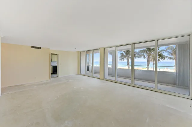 a view of an empty room with sliding glass door