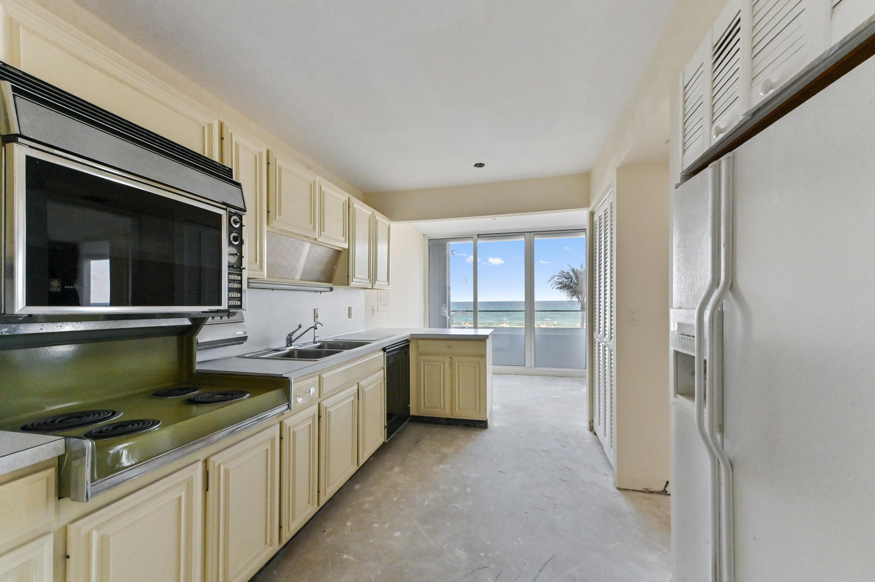 2800 South Ocean Boulevard, Unit 2K Boca Raton, FL 33432 - Photo 9 of 59 a kitchen with stainless steel appliances a stove microwave and refrigerator
