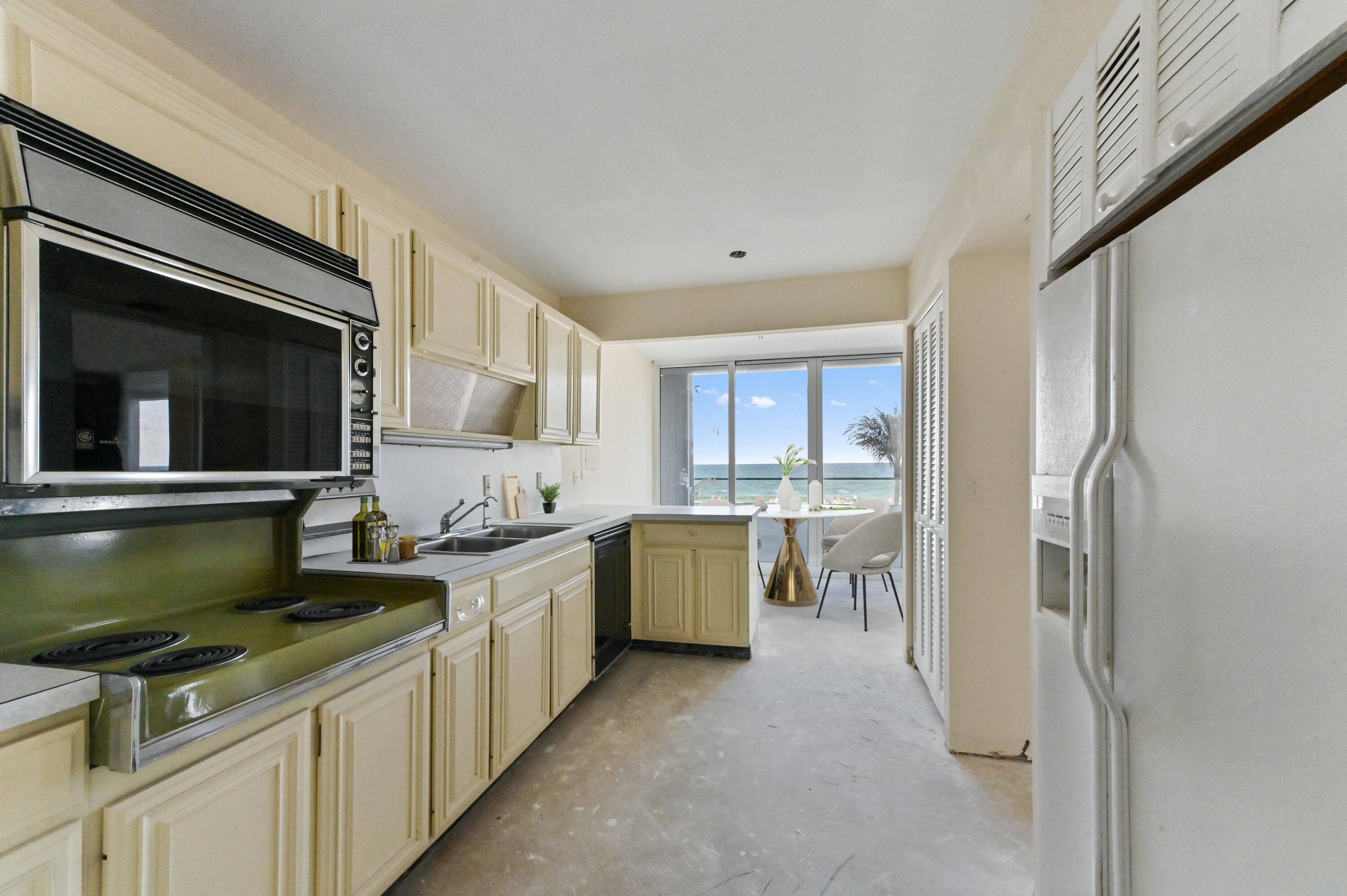 2800 South Ocean Boulevard, Unit 2K Boca Raton, FL 33432 - Photo 10 of 59 a kitchen with a stove and a refrigerator