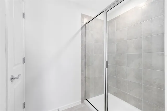a bathroom with a glass shower door