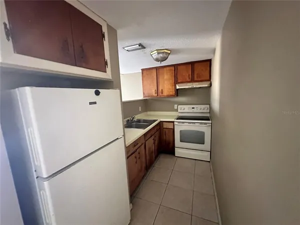 a kitchen with a refrigerator sink and oven