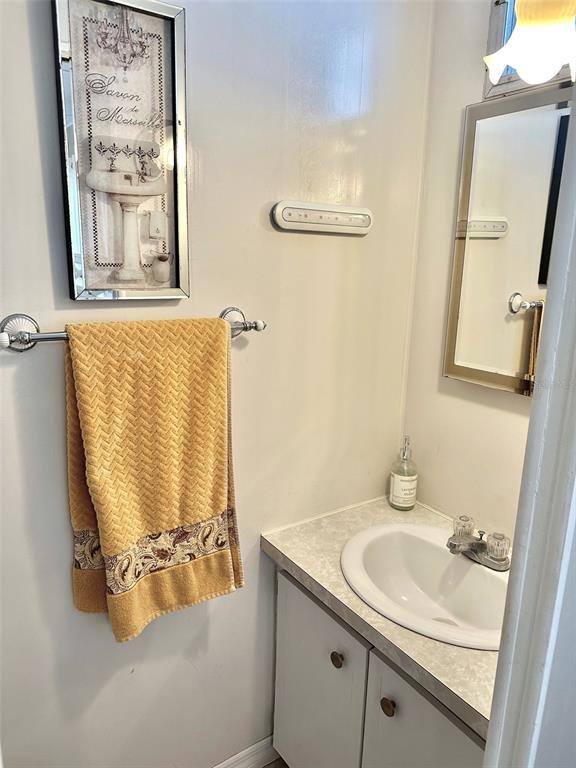 9900 Ulmerton Road, Unit 61 Largo, FL 33771 - Photo 11 of 17 a bathroom with a sink and mirror with bathtub
