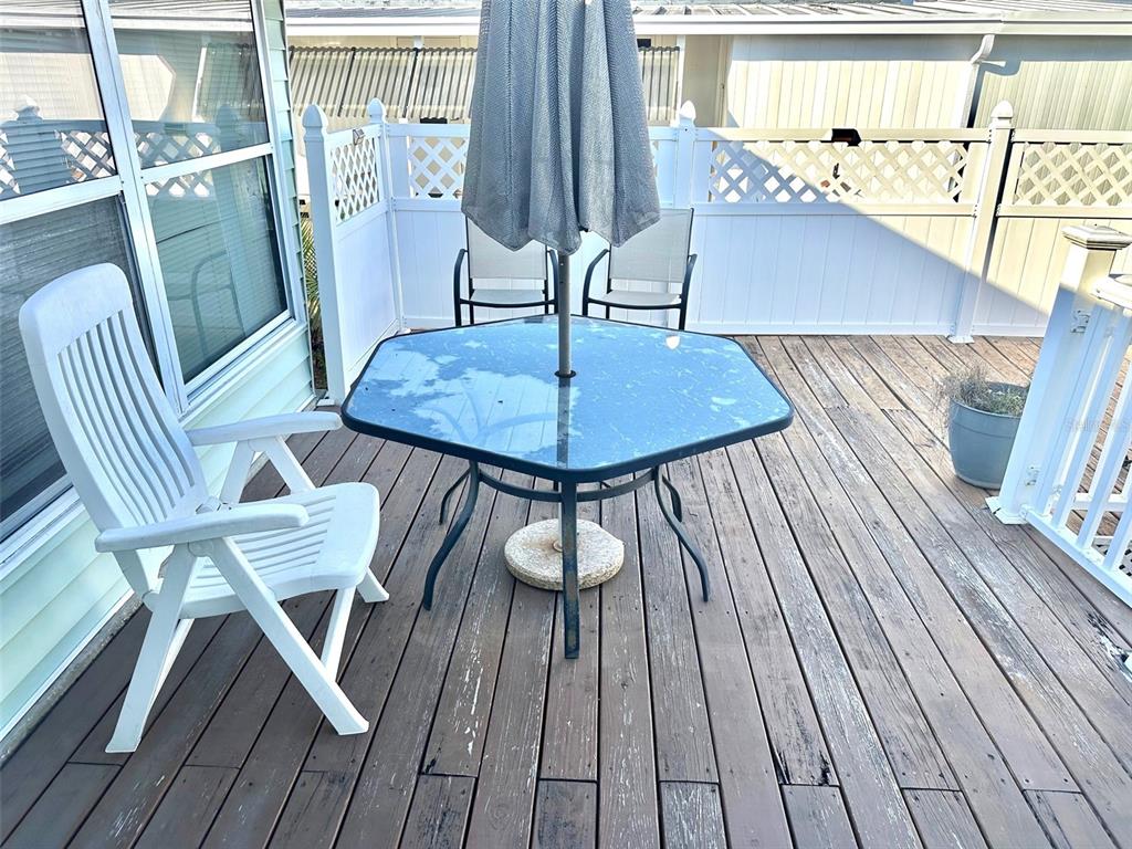9900 Ulmerton Road, Unit 61 Largo, FL 33771 - Photo 14 of 17 a view of a dining room with furniture window and wooden floor