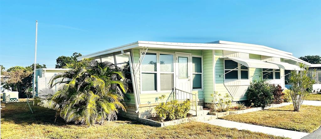 9900 Ulmerton Road, Unit 61 Largo, FL 33771 - Photo 17 of 17 a front view of a house with a yard