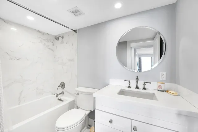 a bathroom with a sink toilet and shower