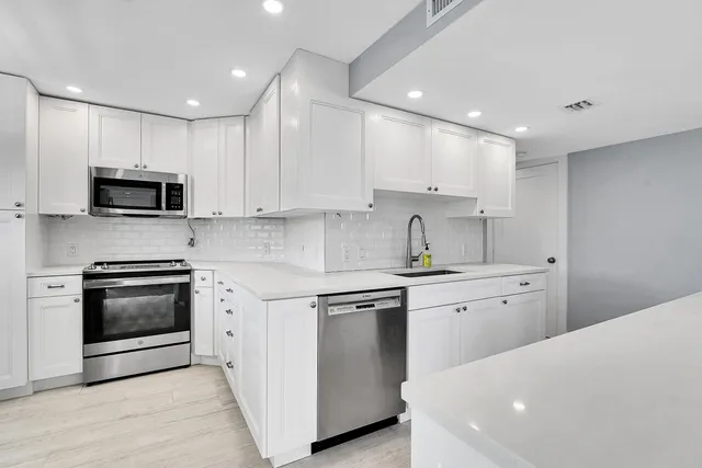 a kitchen with appliances cabinets and a sink