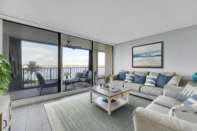 a living room with furniture and a floor to ceiling window