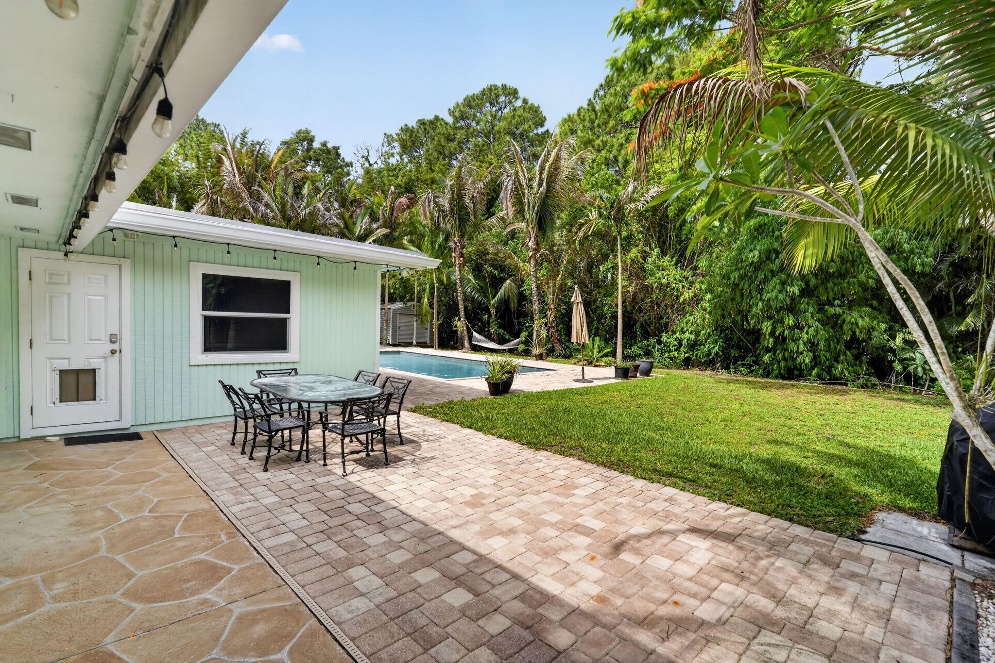 17391 Alexander Run Jupiter, FL 33478 - Photo 44 of 55 a view of a house with backyard and a sitting area