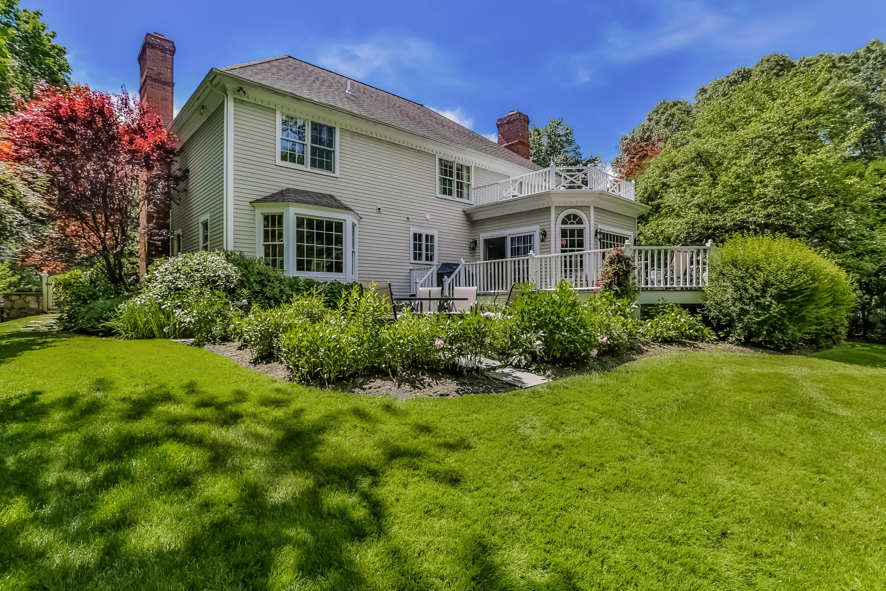 24 Birch Road Darien, CT 06820 - Photo 2 of 20 a view of a white house with a big yard and large trees