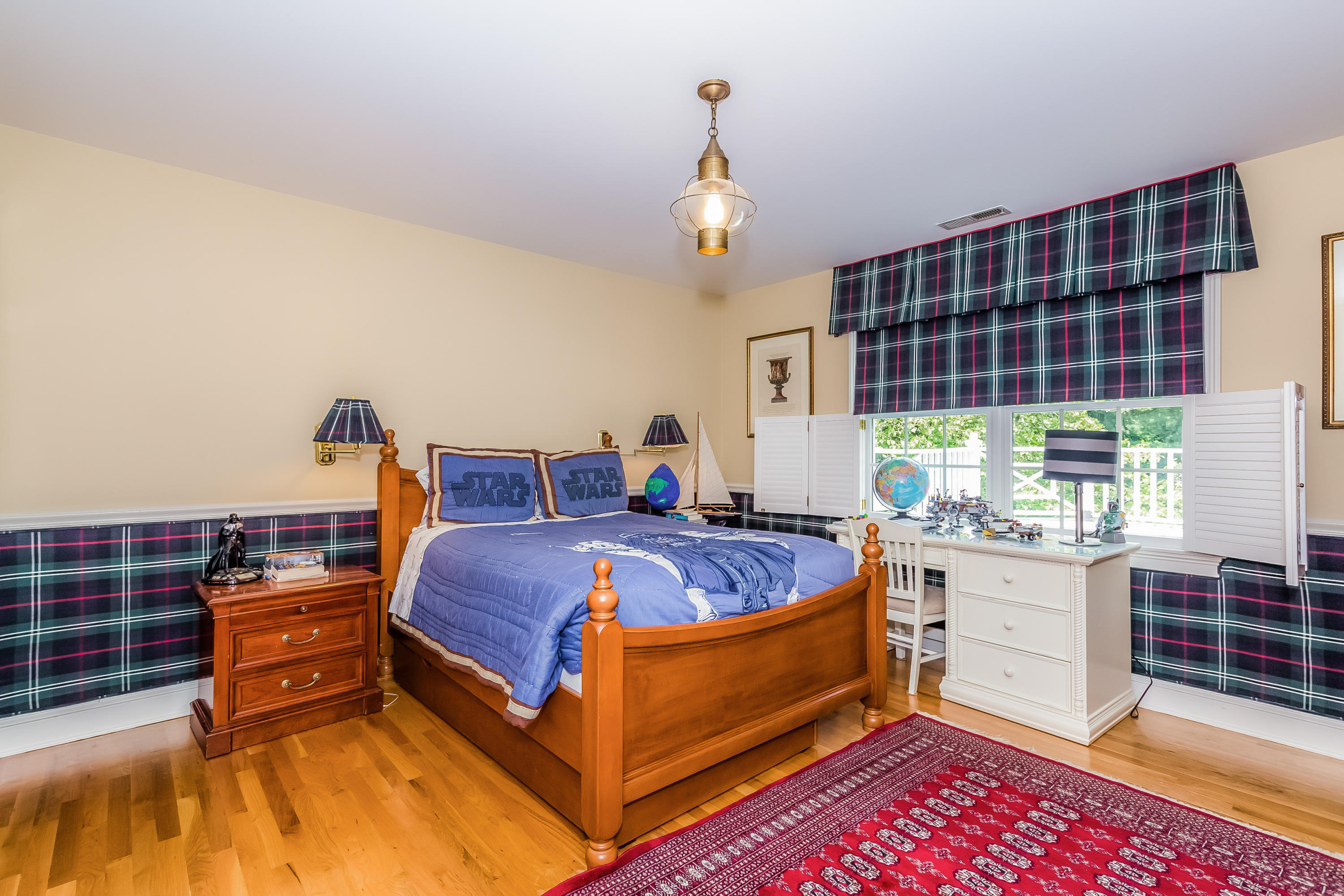 24 Birch Road Darien, CT 06820 - Photo 15 of 20 a bed room with a bed and a chandelier