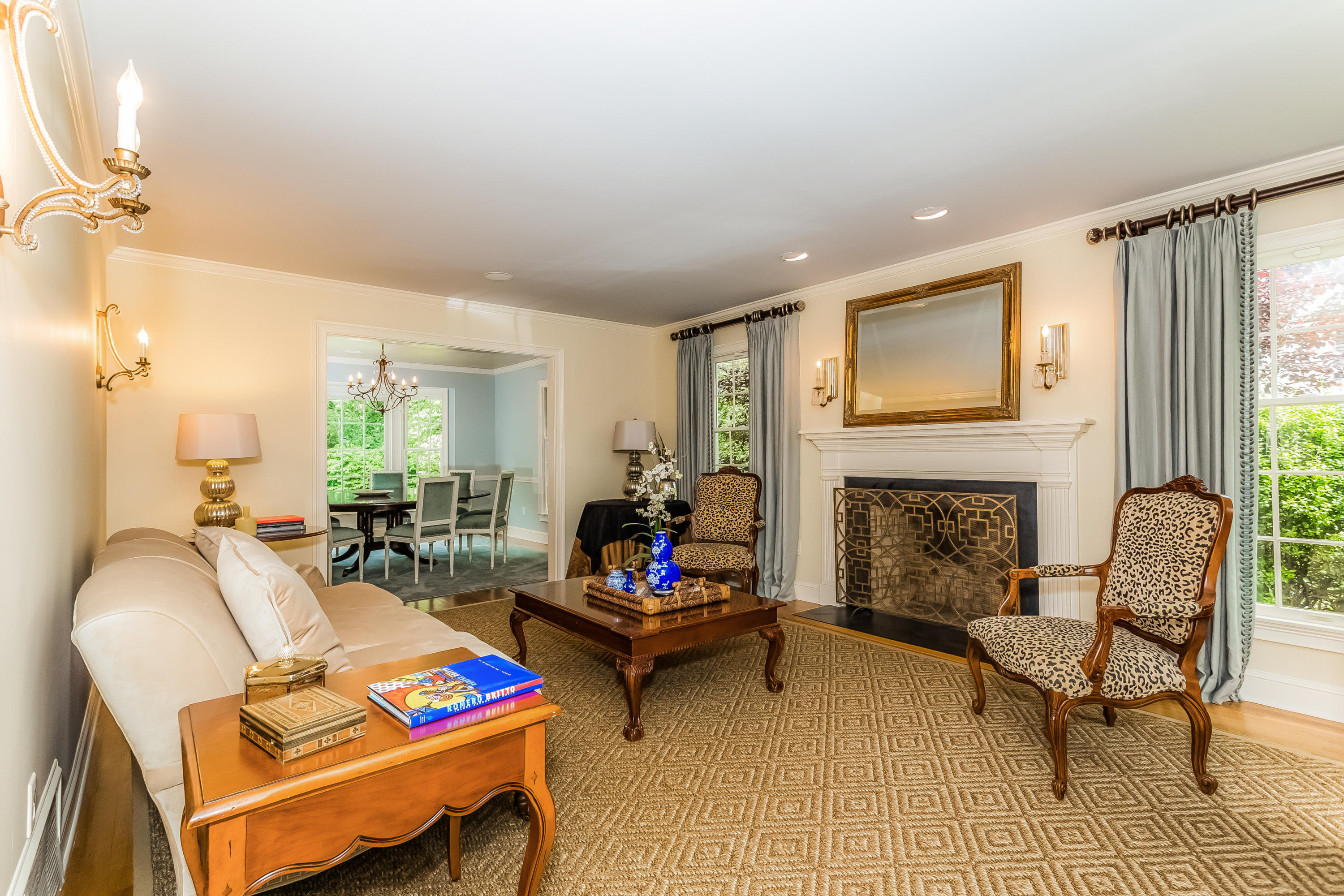 24 Birch Road Darien, CT 06820 - Photo 3 of 20 a living room with furniture a fireplace and a floor to ceiling window