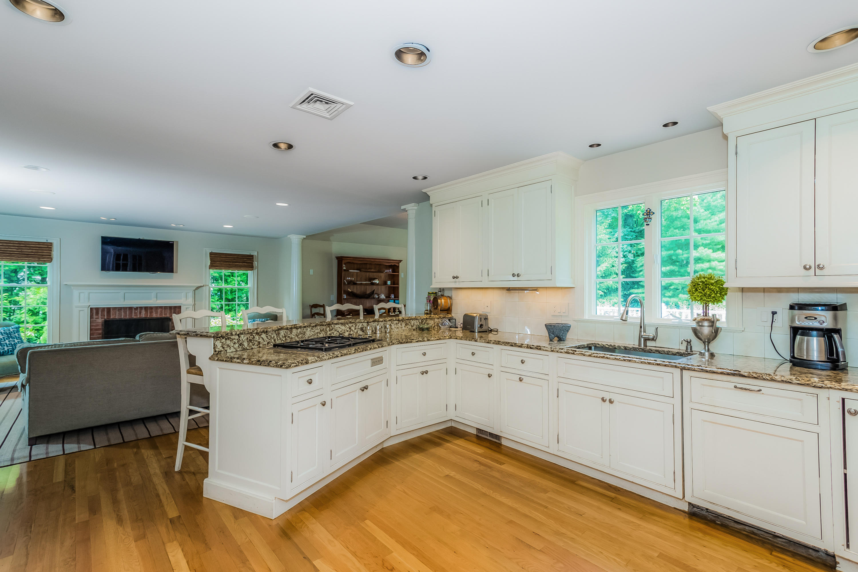 24 Birch Road Darien, CT 06820 - Photo 8 of 20 a kitchen with granite countertop white cabinets and white appliances