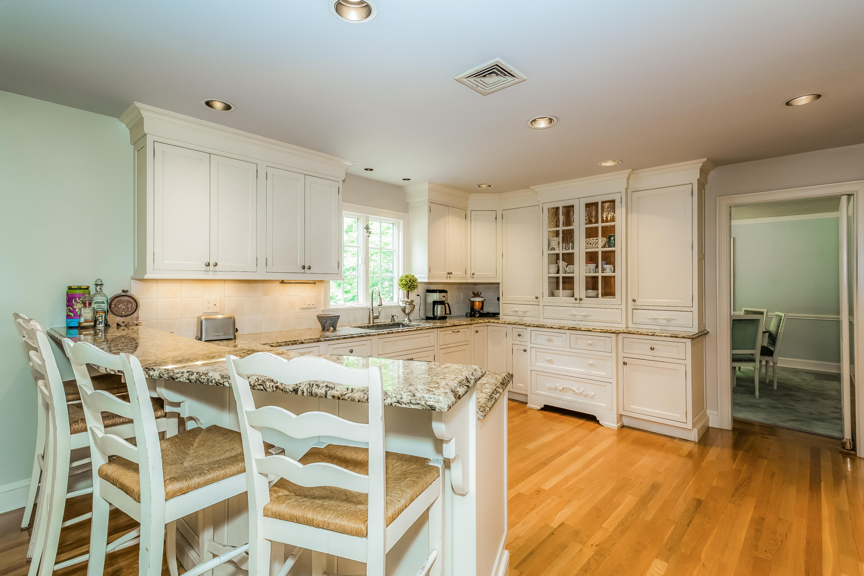 24 Birch Road Darien, CT 06820 - Photo 9 of 20 a kitchen with a table chairs refrigerator and cabinets