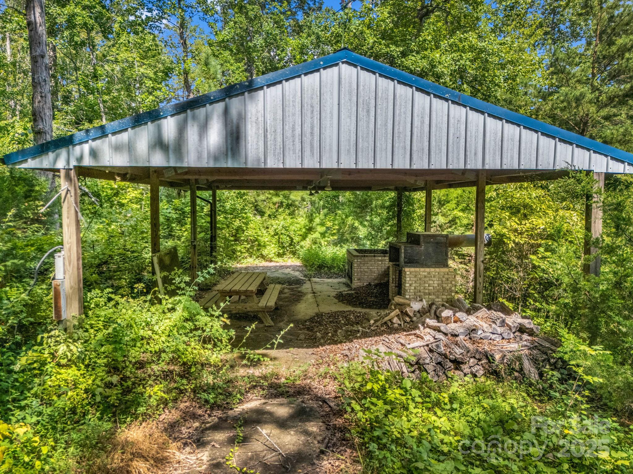 0 Us 64/74a Highway Rutherfordton, NC 28139 - Photo 22 of 37 a backyard of a house with table and chairs under an umbrella
