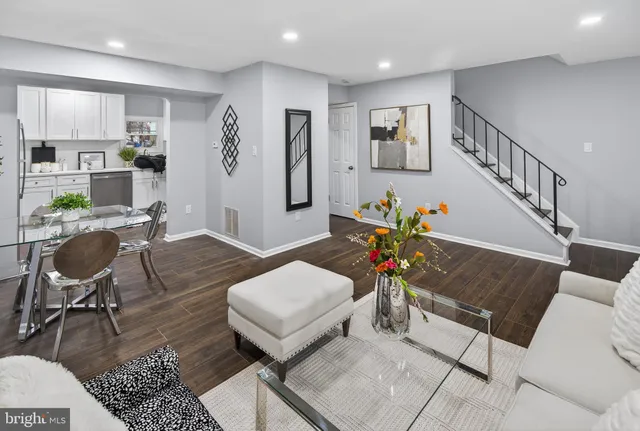 a living room with furniture and wooden floor