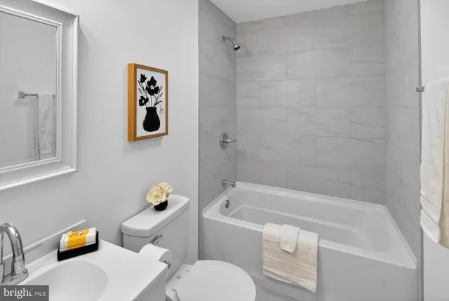a white bath tub sitting next to a white toilet