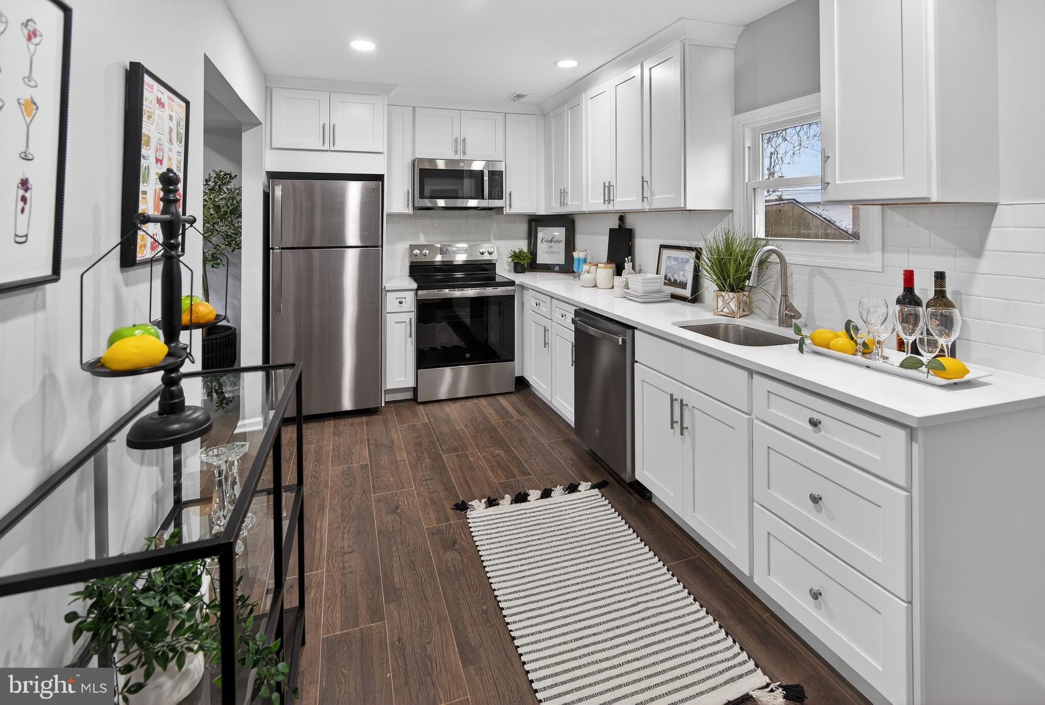 474 St Mary Street Burlington, NJ 08016 - Photo 3 of 30 a kitchen with refrigerator a stove a sink cabinets and wooden floor