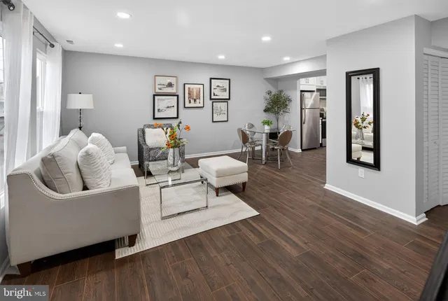 a living room with furniture and wooden floor