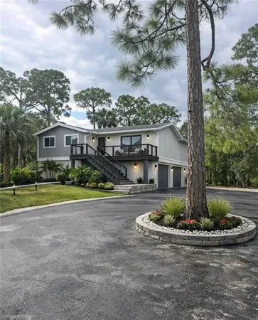 a front view of a house with a yard and fountain