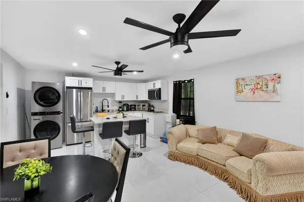 a living room with furniture a clock and a fireplace