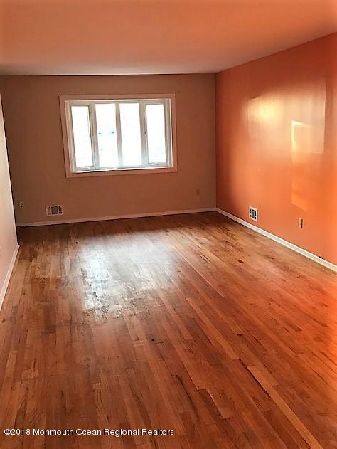 534 Line Road Hazlet, NJ 07730 - Photo 5 of 21 an empty room with wooden floor and windows
