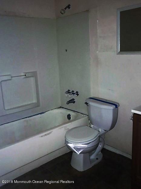 534 Line Road Hazlet, NJ 07730 - Photo 7 of 21 a white toilet sitting next to a bath tub