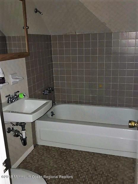 534 Line Road Hazlet, NJ 07730 - Photo 9 of 21 a bathroom with a bathtub a sink and a shower
