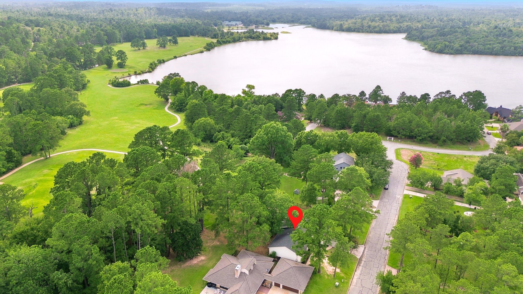22509 Pebble Beach Way Point Blank, TX 77364 - Photo 3 of 30 Aerial of the home's setting on the lake and golf course