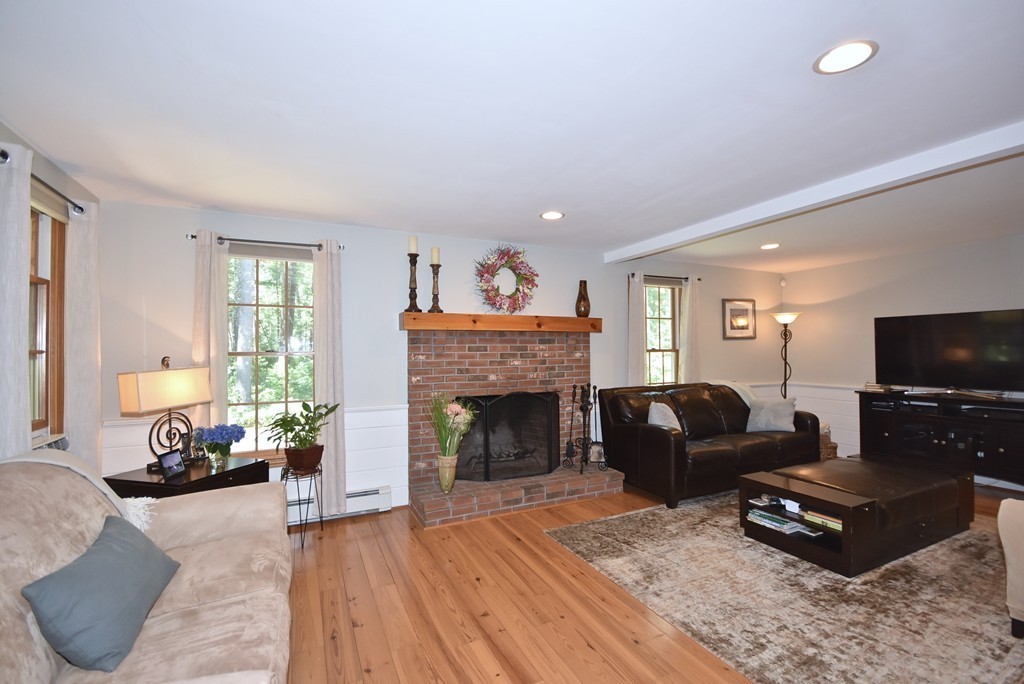 302 Mendell Road Rochester, MA 02770 - Photo 8 of 24 a living room with furniture a flat screen tv and a fireplace