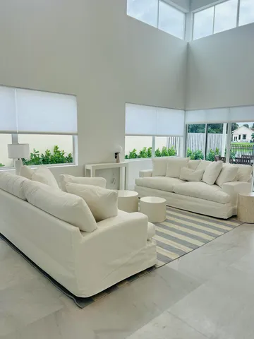 a kitchen with stainless steel appliances a refrigerator and white cabinets