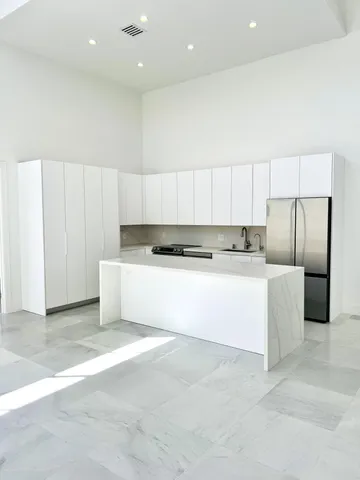 a bathroom with a toilet a sink a mirror and vanity