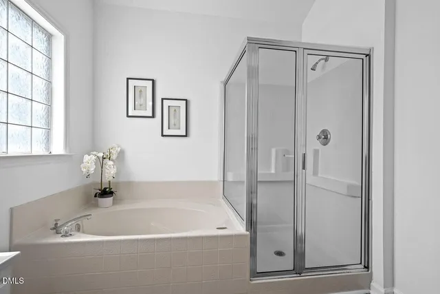 a bathroom with a tub and shower