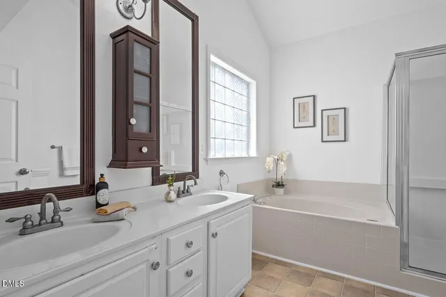 a bathroom with 2 sink tub and a mirror
