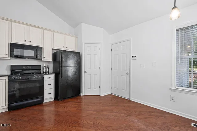 a kitchen with a refrigerator and a stove