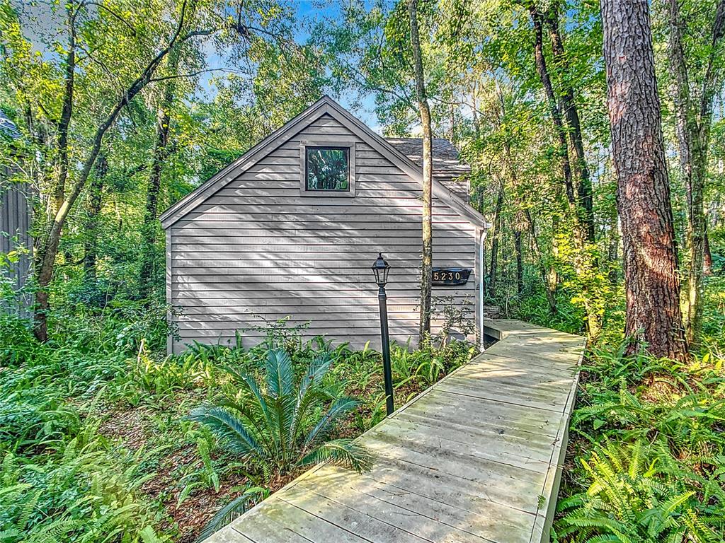 5230 Southwest 86 Terrace Gainesville, FL 32608 - Photo 1 of 1 a view of a pathway of a house with wooden fence