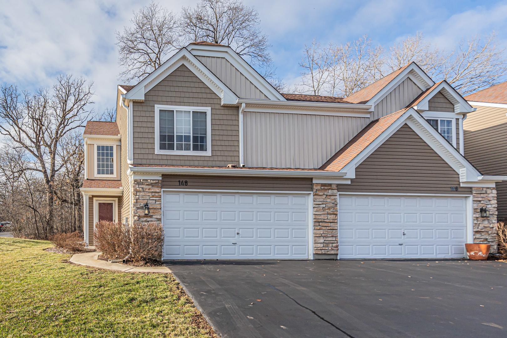 148 Locksley Drive Streamwood, IL 60107 - Photo 19 of 20 a front view of a house with a yard and garage