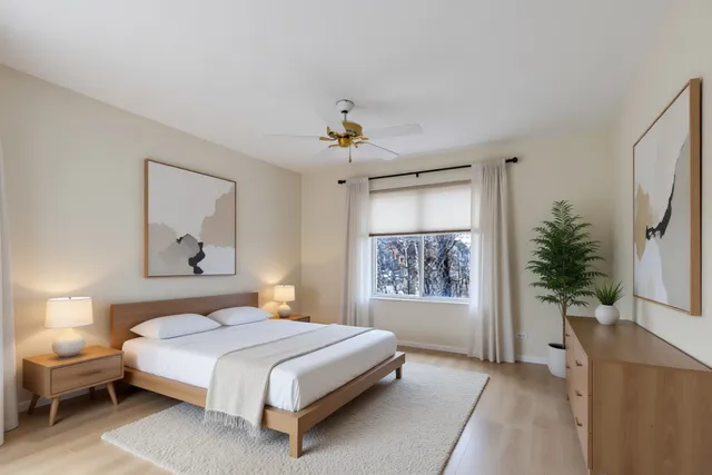 a spacious bedroom with a large bed and a window