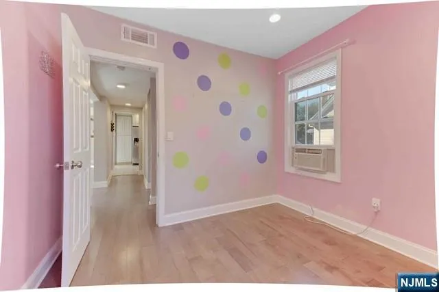 a very nice looking room with wooden floor and windows