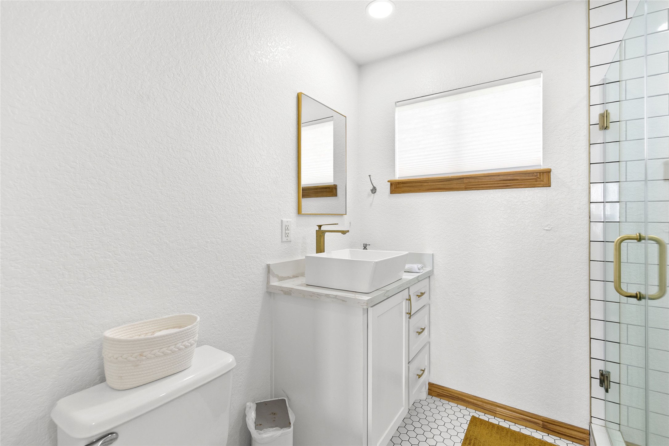 902 Beach Drive Surfside Beach, TX 77541 - Photo 11 of 22 a bathroom with a toilet sink and mirror