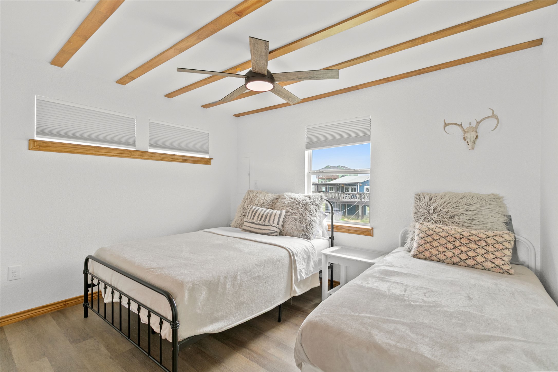902 Beach Drive Surfside Beach, TX 77541 - Photo 9 of 22 a bedroom with two beds and fan