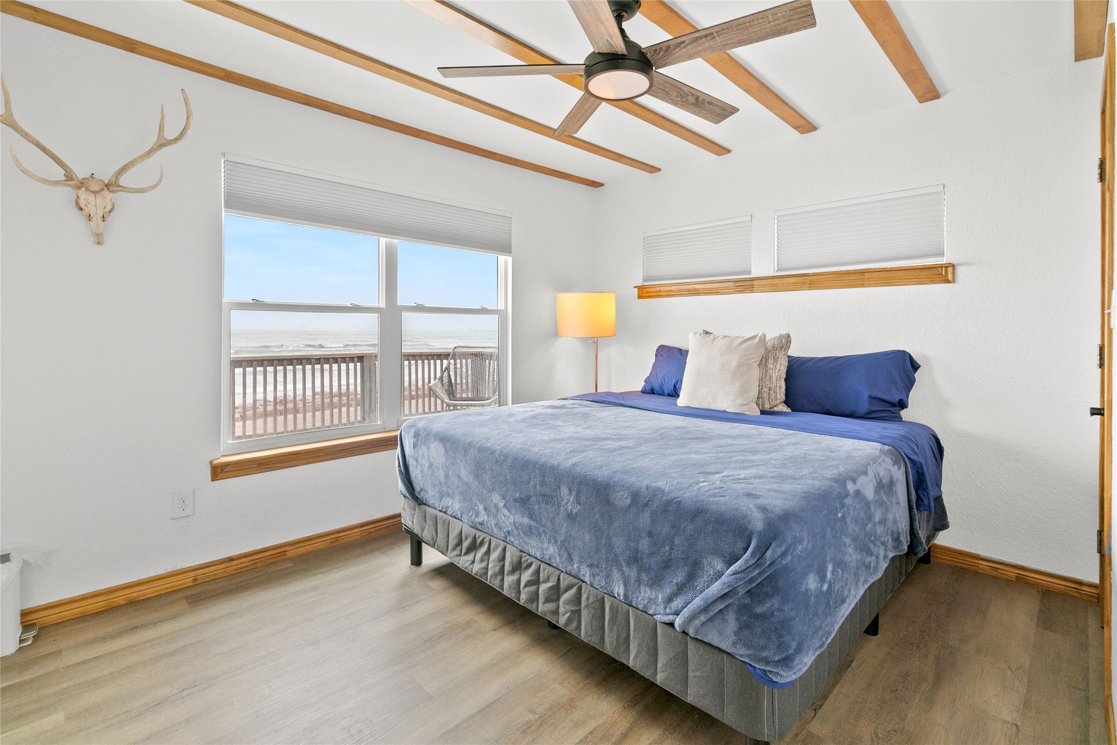 902 Beach Drive Surfside Beach, TX 77541 - Photo 10 of 22 a bedroom with a bed and wooden floor