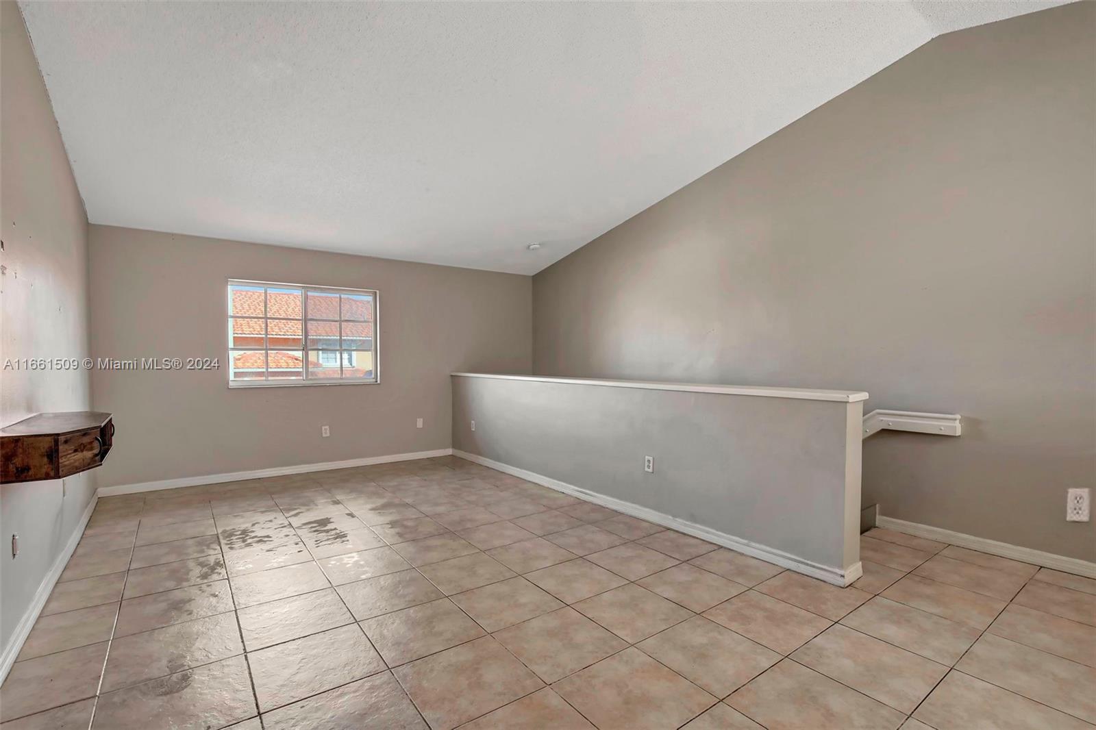 2527 West 76th Street, Unit 208 Hialeah, FL 33016 - Photo 12 of 37 a view of an empty room and window