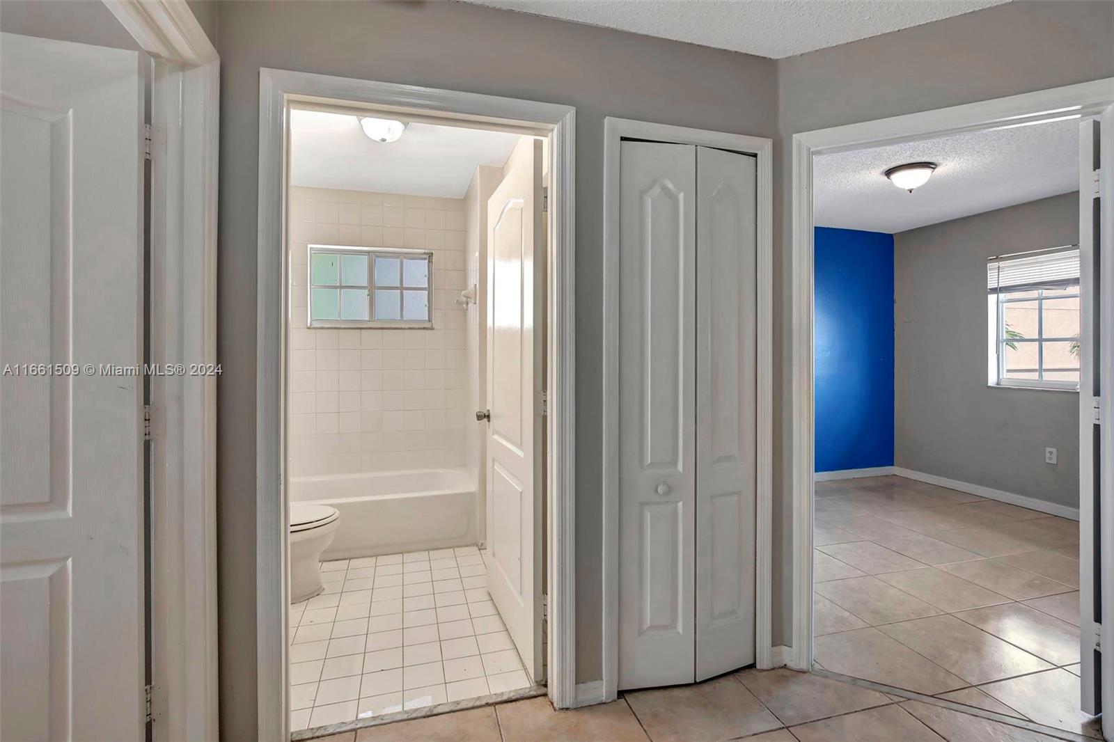 2527 West 76th Street, Unit 208 Hialeah, FL 33016 - Photo 19 of 37 a view of an empty room with windows and bathroom