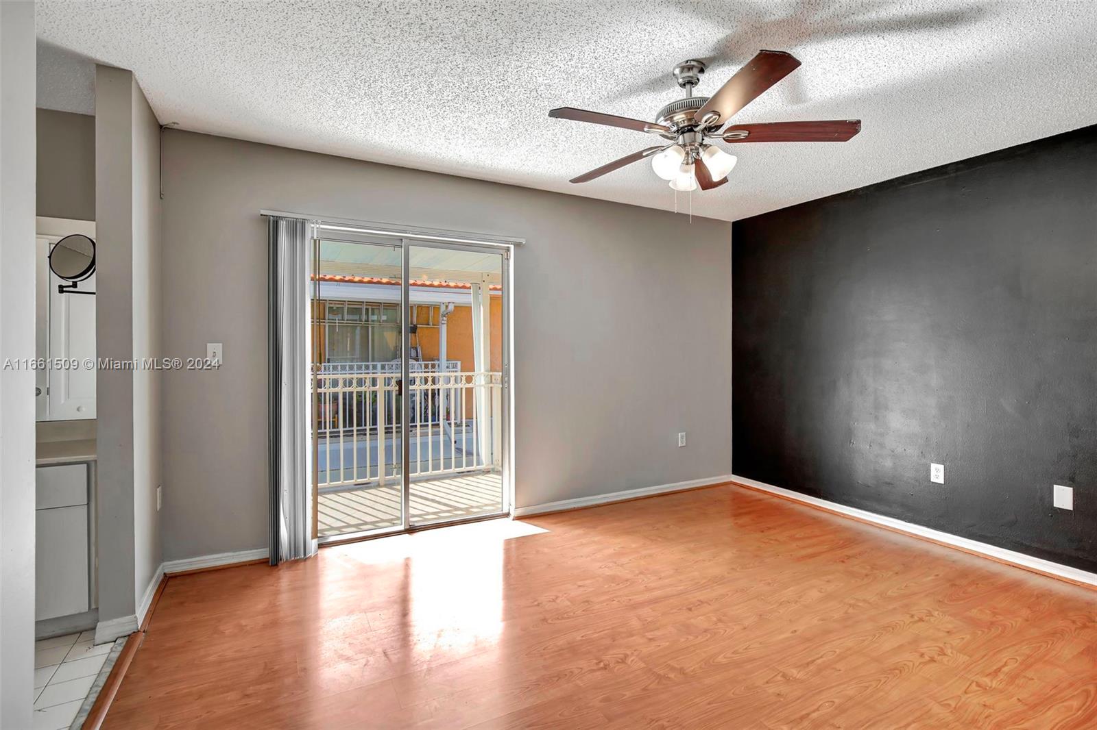 2527 West 76th Street, Unit 208 Hialeah, FL 33016 - Photo 20 of 37 a view of a livingroom with a ceiling fan and window