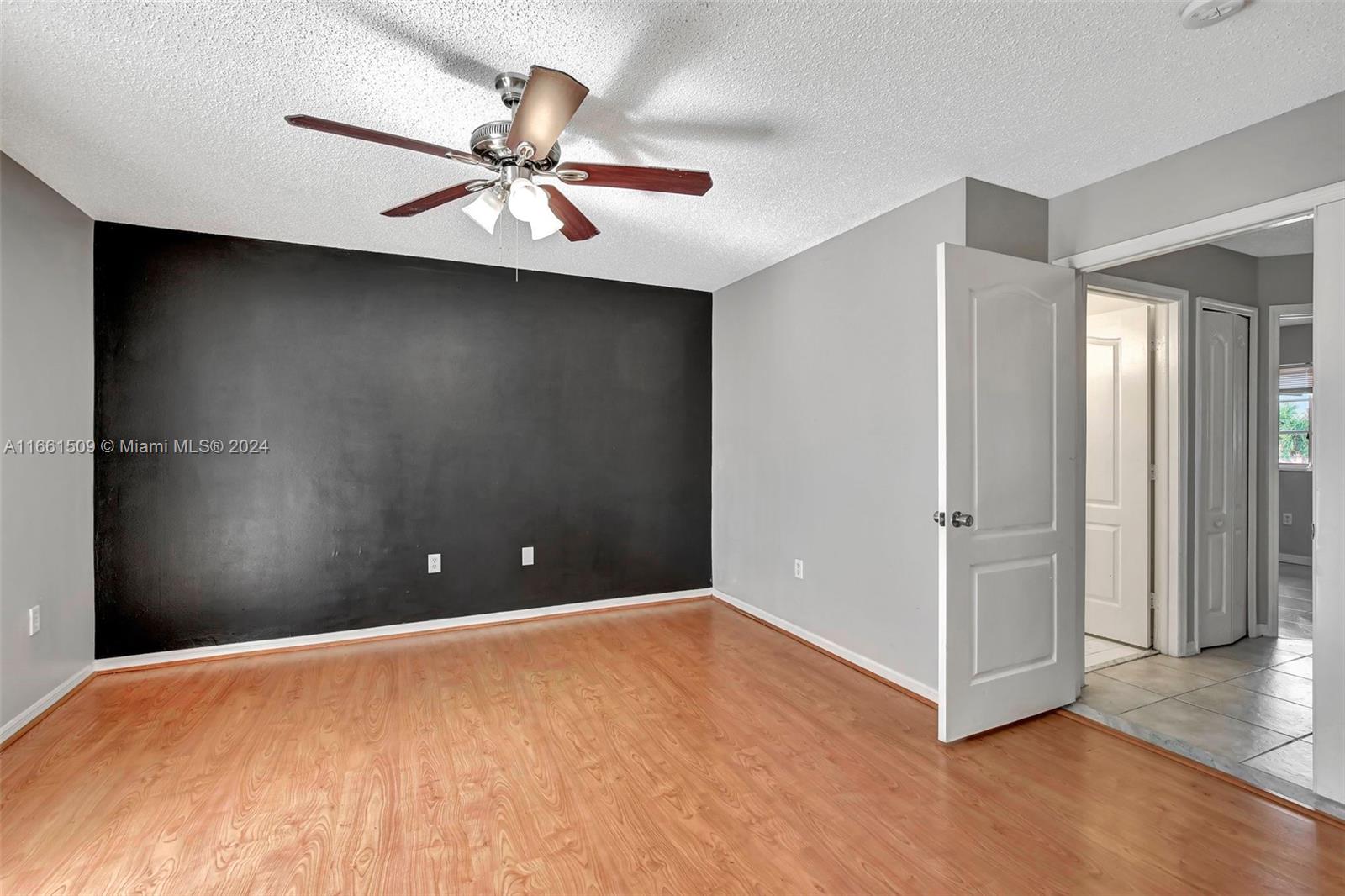 2527 West 76th Street, Unit 208 Hialeah, FL 33016 - Photo 25 of 37 a view of a livingroom with a ceiling fan and closet